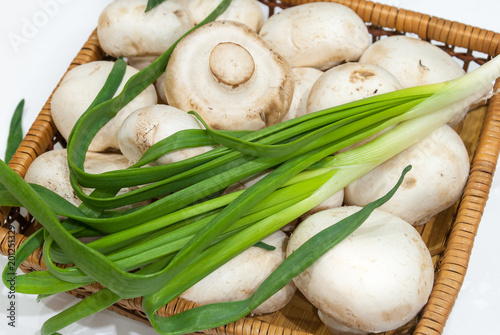 Fresh champignons with green onions