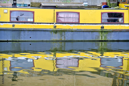 reflection of a yellow boat in the London canal, photo