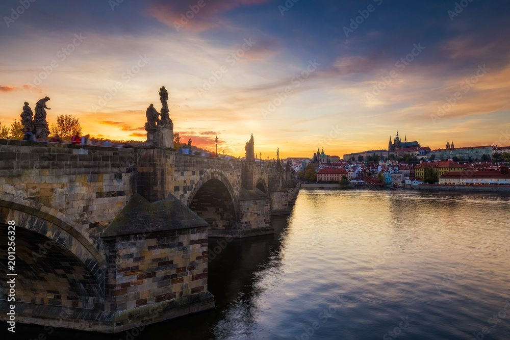 Famous iconic image of Charles bridge at sunset in spring, Prague, Czech Republic. Concept of world travel, sightseeing and tourism.