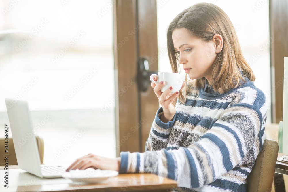 Businesswoman looking in to a laptop Businesswoman looking in to a laptop