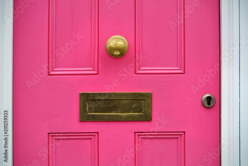 detail of pink door with letterbox,