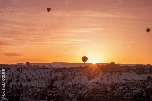 silhoutte of balloon on sunrise. famous hot air balloon flying over valley. Goreme, Cappadocia, Turkey.