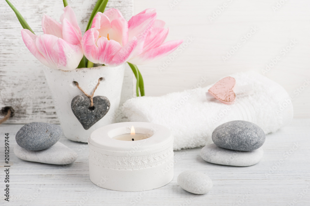Pink tulips, pebbles and lit candle Pink tulips, pebbles and lit candle