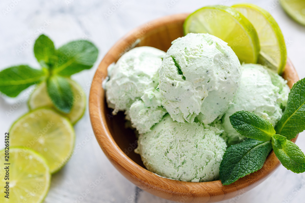 Mojito ice cream with lime slices and mint sprigs. Mojito ice cream with lime slices and mint sprigs.