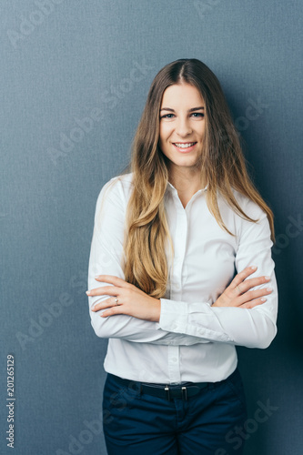 Relaxed confident young woman with folded arms