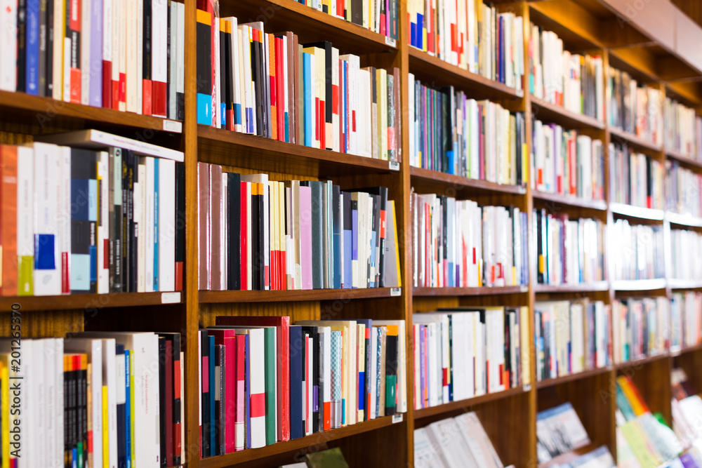 Naklejka premium books on shelves in library