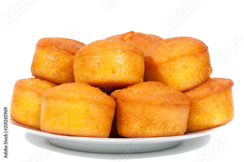 Corn bread on a plate partially isolated on white background.