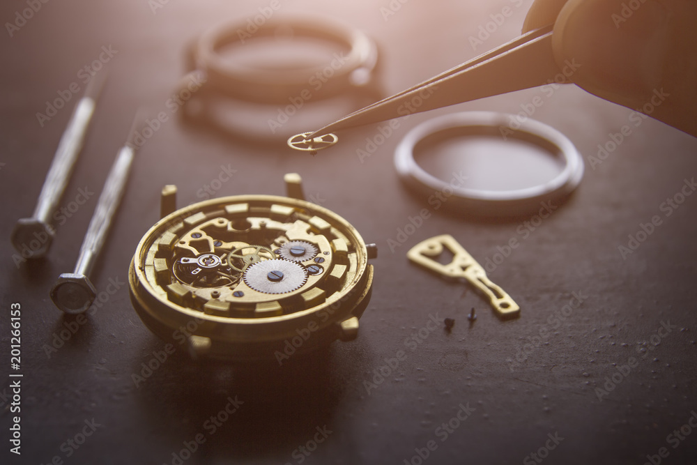 Watchmaker is repairing the mechanical watches in his workshop Watchmaker is repairing the mechanical watches in his workshop