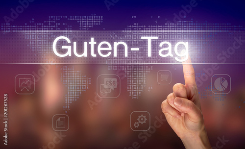 A businessman pressing a Good Day "Guten-Tag" button in German on a futuristic computer display
