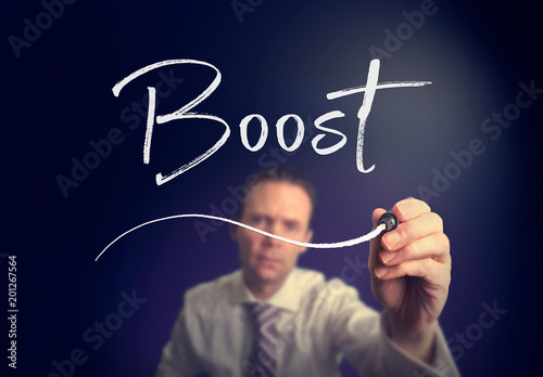 A businessman writing a Boost concept with a white pen on a clear screen.
