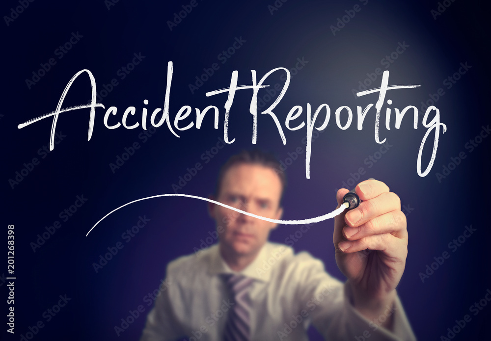 A businessman writing a Accident Reporting concept with a white pen on a clear screen. A businessman writing a Accident Reporting concept with a white pen on a clear screen.