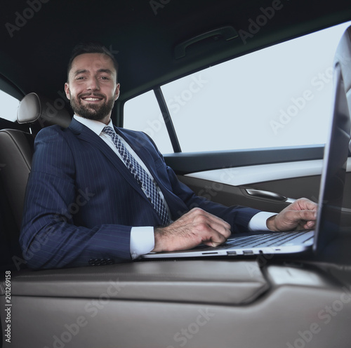 successful man working with laptop sitting in car © ASDF