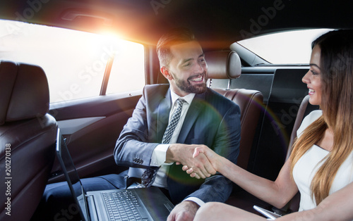 Handshake of business people in the back seat of a car © ASDF