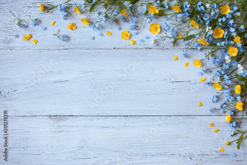 Fototapeta Naklejka Na Ścianę i Meble -  Spring and summer flowers forget-me-nots, buttercups on a wooden background