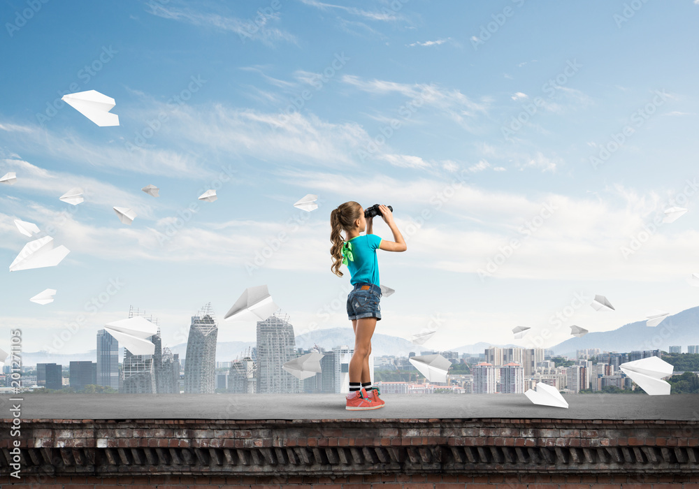 Concept of careless happy childhood with girl of school age looking in future Concept of careless happy childhood with girl of school age looking in future