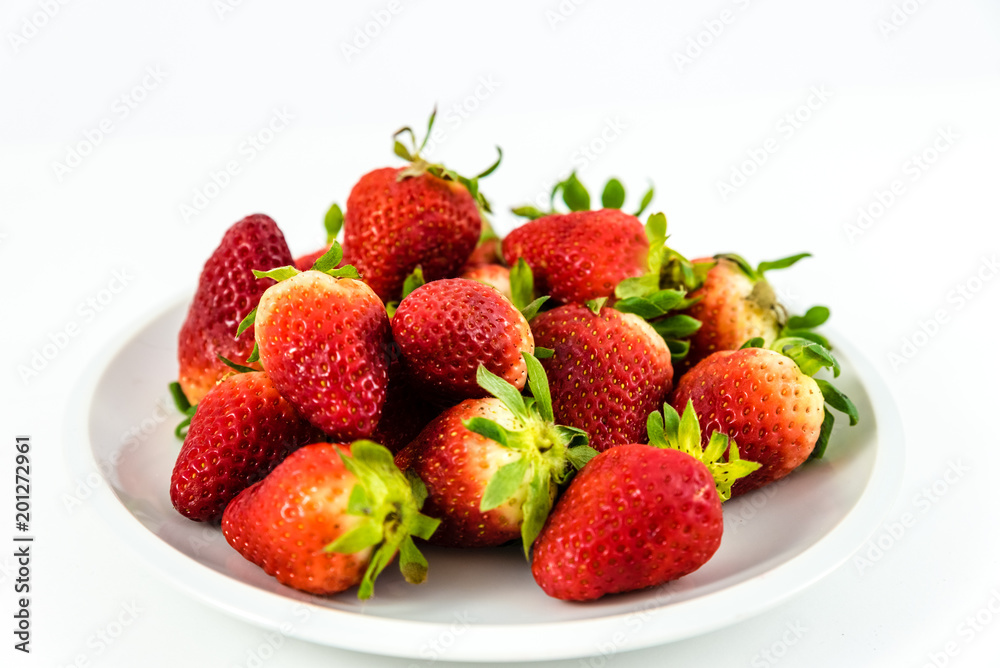 strawberries in white porcelain dish with white background strawberries in white porcelain dish with white background