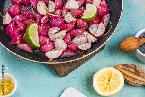 cooked spring radish with poopy seeds and lemon photo