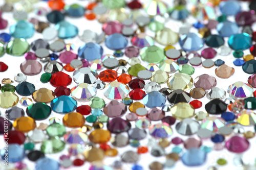Many scattered rhinestones. On a white background