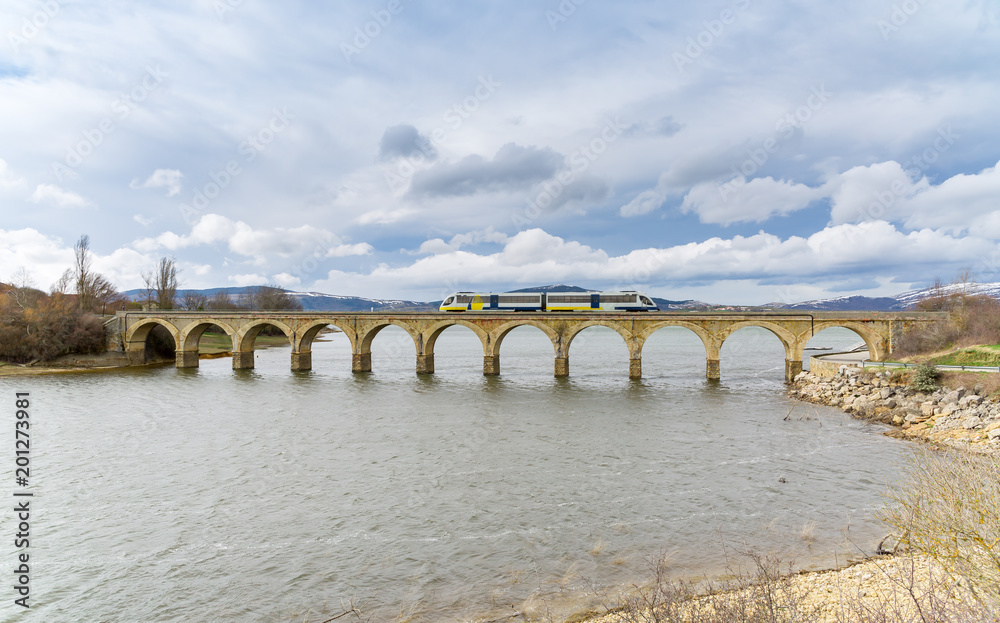 Fototapeta premium The train as it passes through Arija, Burgos, Spain