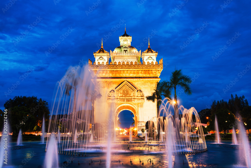 Patuxay park at night with illuminated Gate of Victory in Vientiane, Laos