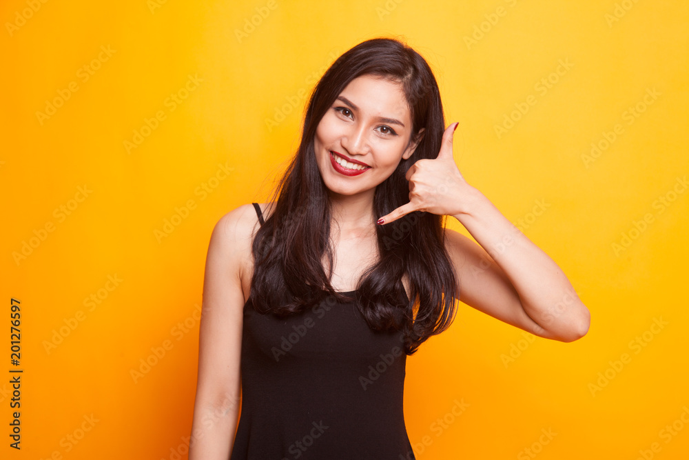 Young Asian woman show with phone gesture and OK sign. Young Asian woman show with phone gesture and OK sign.