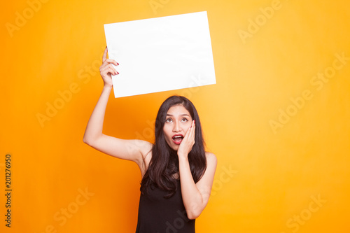 Young Asian woman show thumbs up with white blank sign.