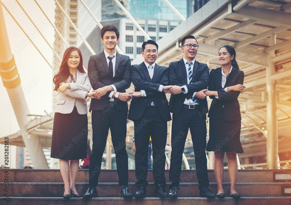 Fototapeta premium Business team up and holding hands on the ladder.