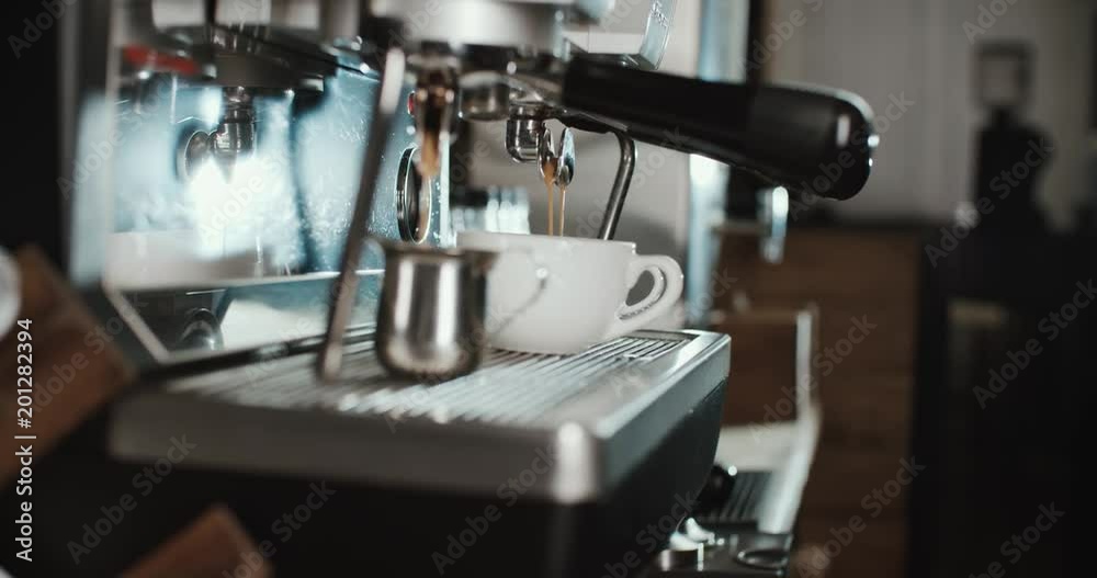 Barista at work in the cafe, close-up. Coffee making process in professional coffee machine. Barista at work in the cafe, close-up. Coffee making process in professional coffee machine.