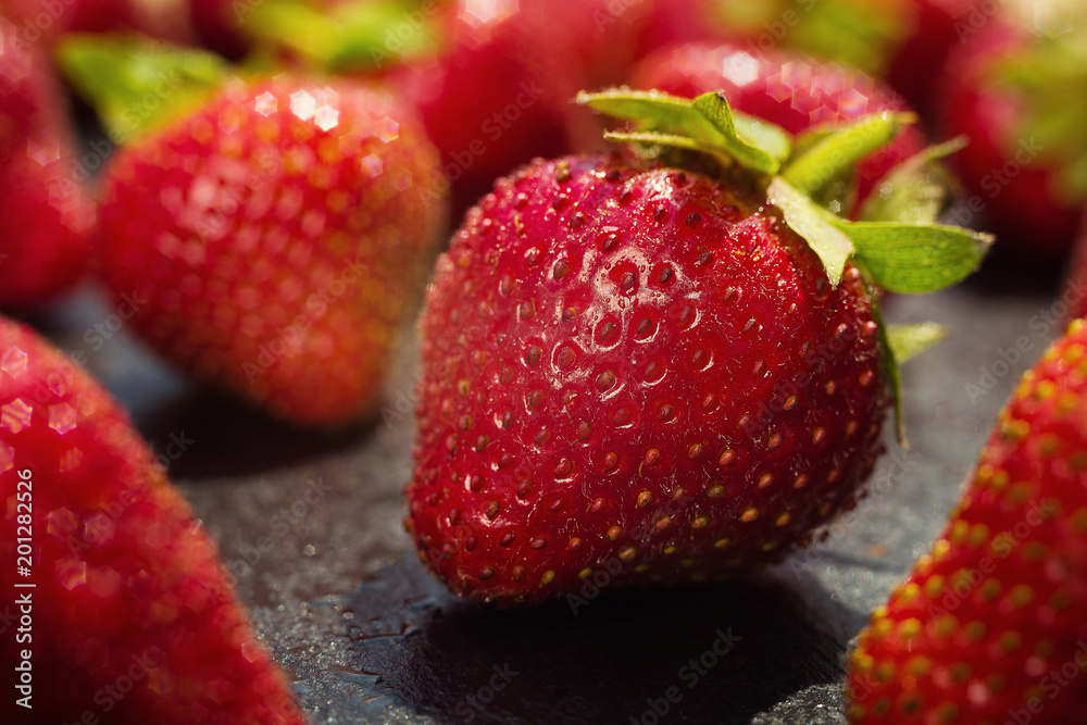 strawberries on stone background, delicious first class organic fruit as a concept of summer vitamins strawberries on stone background, delicious first class organic fruit as a concept of summer vitamins