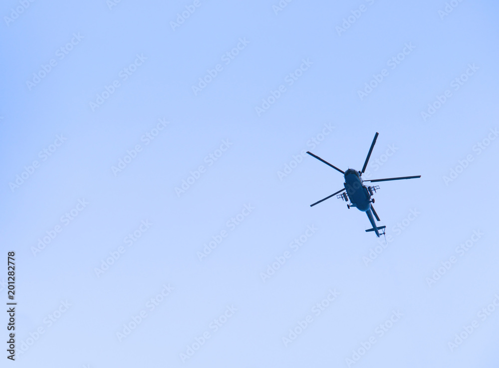 The military helicopter in the blue sky above me high. High in the sky aviation. The military helicopter in the blue sky above me high. High in the sky aviation.