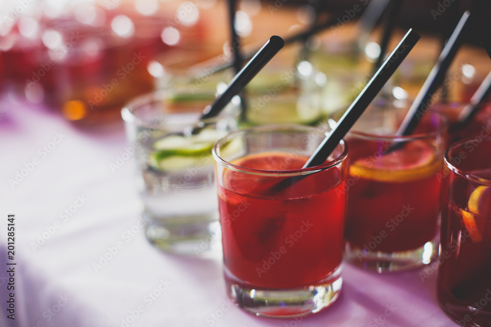 Beautiful row line of different colored alcohol cocktails on a party on decorated catering banquet table
Beautiful row line of different colored alcohol cocktails on a party on decorated catering banquet table
