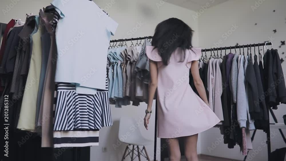 Woman posing in new dress in showroom Woman posing in new dress in showroom
