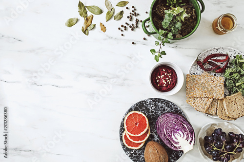 Fototapeta Naklejka Na Ścianę i Meble -  Top view of different organic food on the white marble table background. Enjoy healthy diet. Copy space for slogan. 