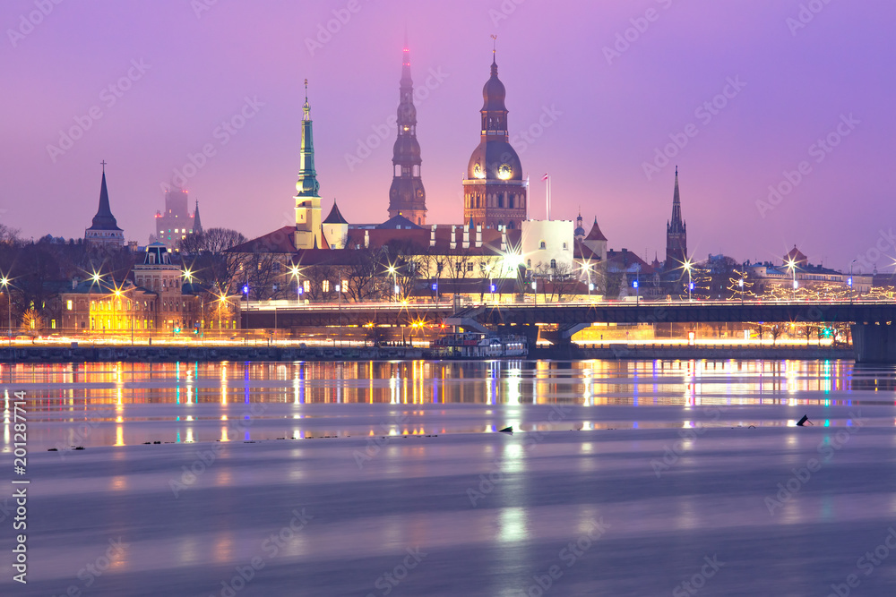 Old Town of Riga and River Daugava at night, Riga Cathedral, Saint Peter church and Riga castle in the background, Latvia