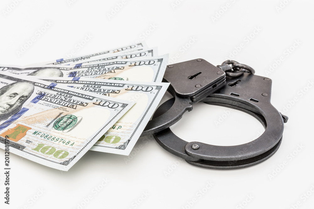 hundred dollar bills are on handcuffs on a white background hundred dollar bills are on handcuffs on a white background