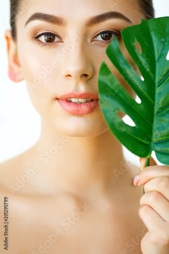 Skin Care. Beautiful Girl with Green Leaves. Beauty Treatment. Cosmetology. Beauty Spa Salon