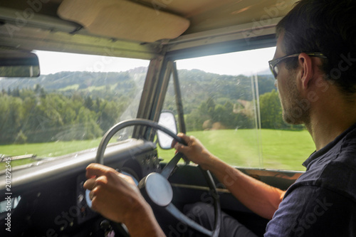 caucasian man driving a off road jeep