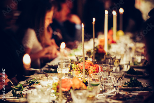 People dining at table with candles photo