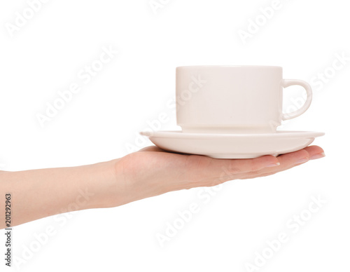 White cup and saucer in hands