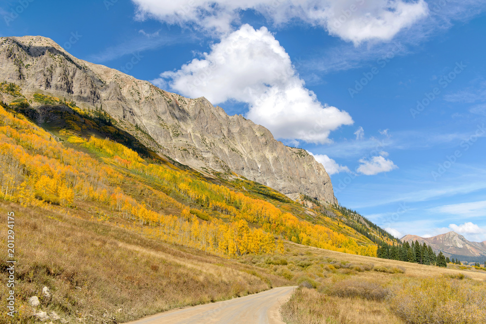 Autumn in Rockies - Autumn view of aspen groves at side of Gothic Mountain in West Elk Mountains range of Rocky Mountains, near Crested Butte, Colorado, USA.