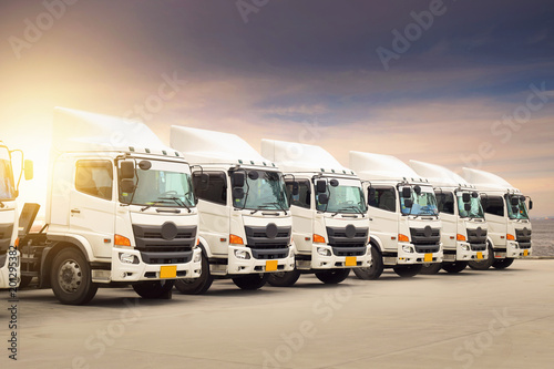 New haulage truck fleet in container depot as transporatation, shipping and logistics business.
