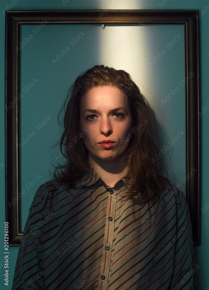 vibrant studio portrait of a joyful caucasian woman, frame in the frame, blue background vibrant studio portrait of a joyful caucasian woman, frame in the frame, blue background