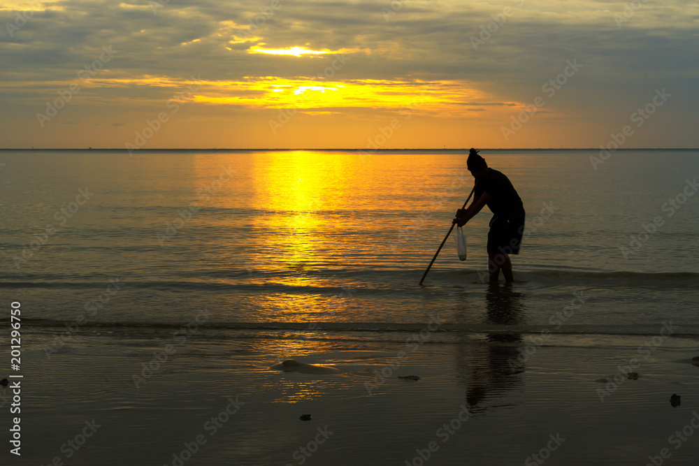 Sunrise fisherman and background in beach