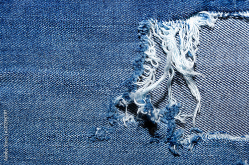 Blue Jean texture with a hole and threads 