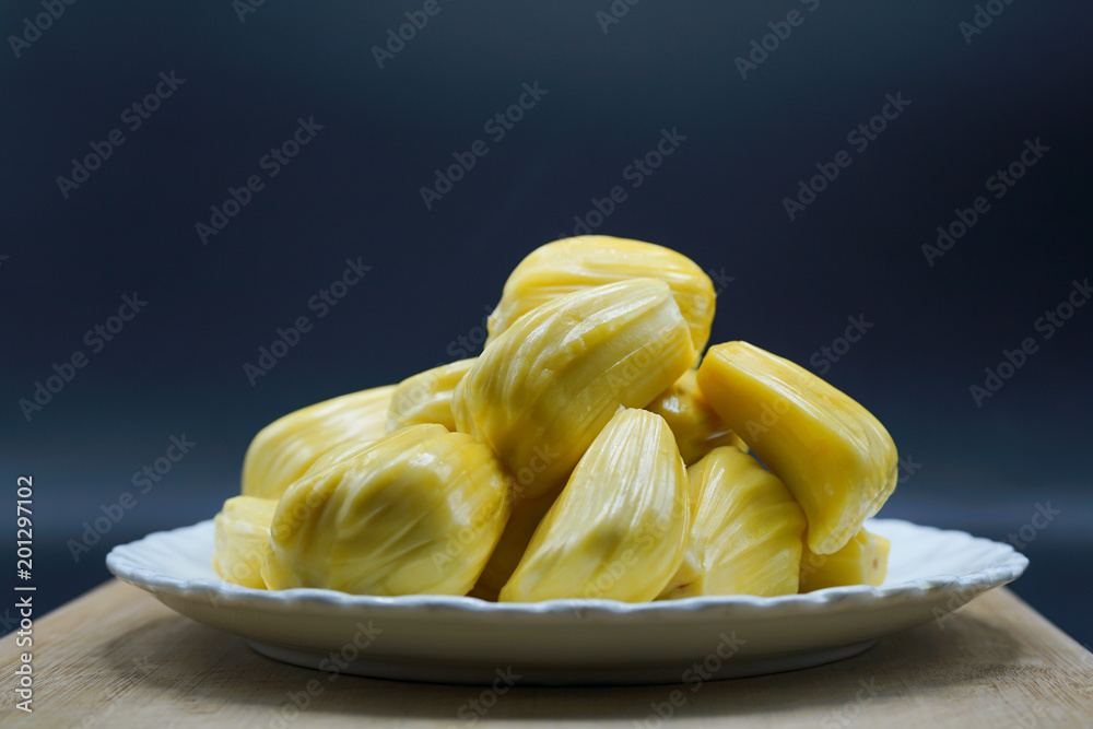 Fresh jackfruit slices on a white plate. sweet yellow jackfruit ripe. vegetarian, vegan, raw food. Exotic tropical fruit - isolated