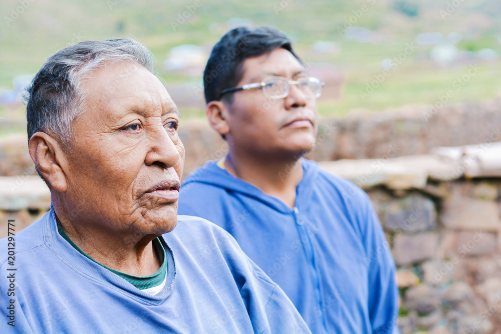 Old serious native american father with his son in the countryside. Old serious native american father with his son in the countryside.