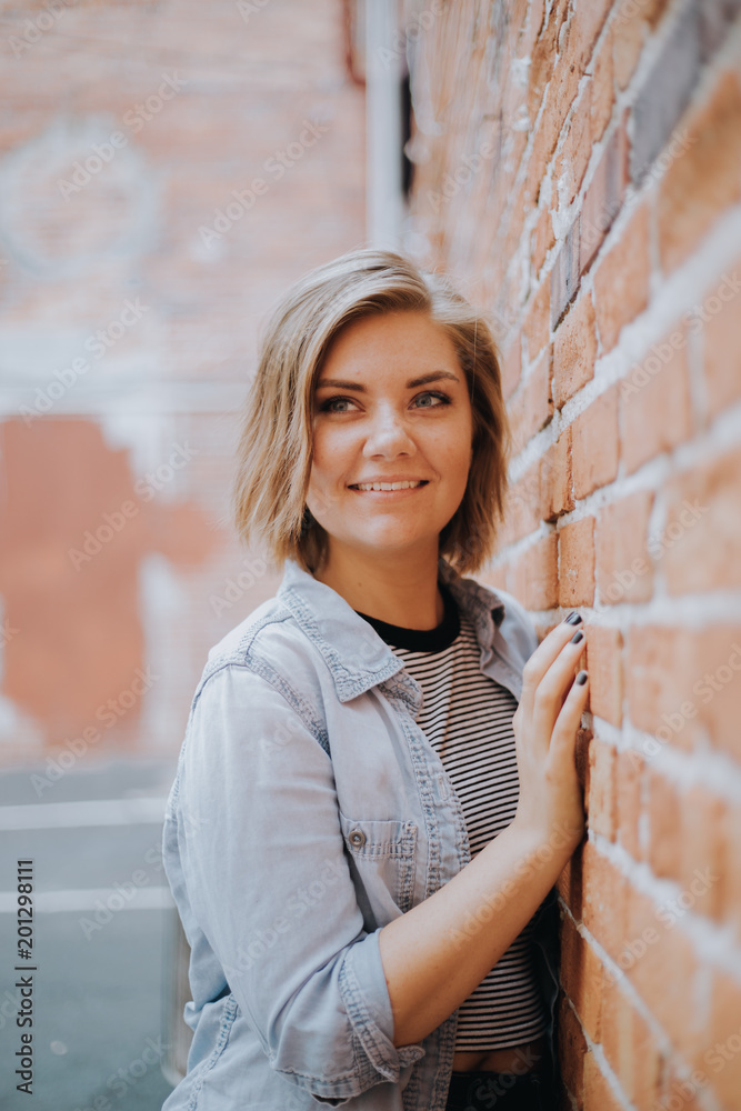 Cute Attractive Young Woman Modeling on Brick Wall Cute Attractive Young Woman Modeling on Brick Wall