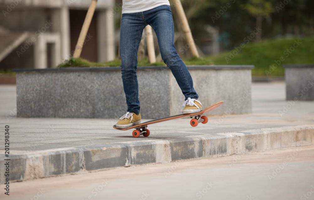 Skateboarder riding skateboard going down the step Skateboarder riding skateboard going down the step
