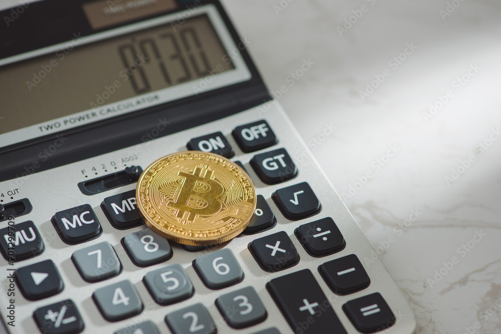 Golden bitcoin with calculator on white background Golden bitcoin with calculator on white background