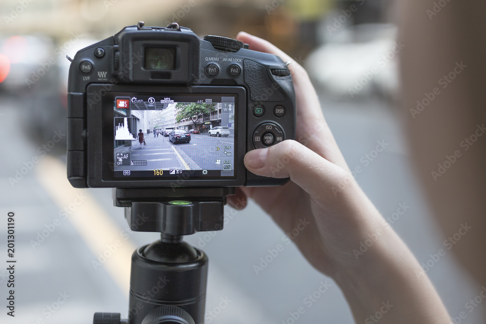 Camera recording footage of street, selective focus on camera